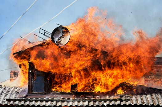 fire on the roof of a wooden house. High quality photo