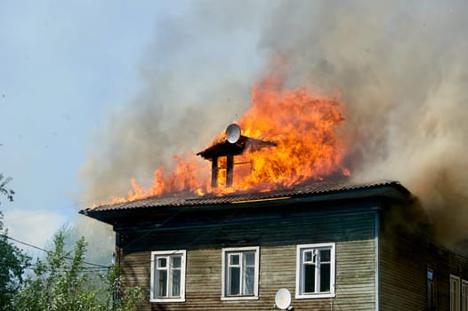 fire on the roof of a wooden house. High quality photo