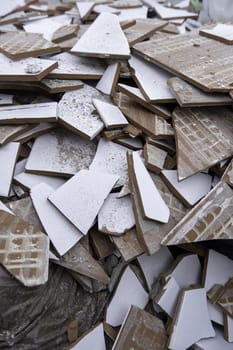 Detail of old broken tiles at a construction site in a house
