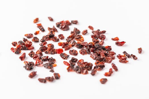 Pile of dried Berberis vulgaris, common barberry, European barberry or barberry. Edible herbal medicinal red fruit plant.