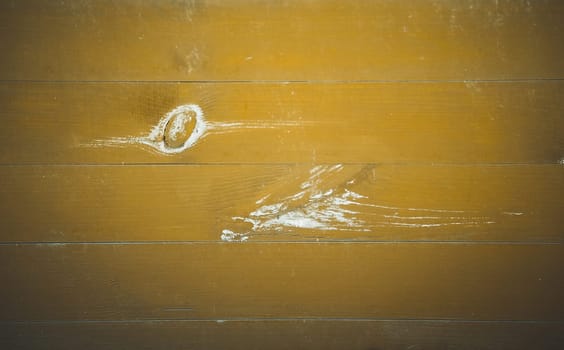 Horizontal green wooden board with knots on the surface in close-up. Texture or background