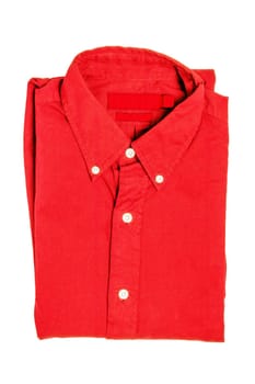 Folded clothes. Close-up of a  new red business shirt isolated on a white background. Mens shirt. Clipping path. Summer fashion. Background texture with space.