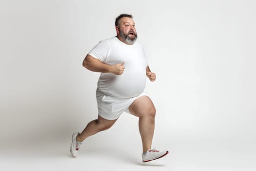Overweight senior Caucasian man running on white background, concept of overweight and weight loss. Neural network generated image. Not based on any actual person or scene.