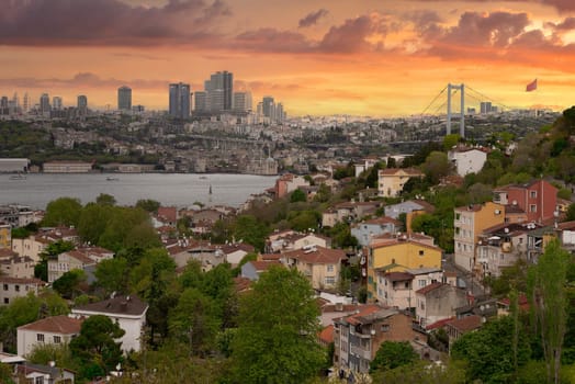 Cityscape of Istanbul, Turkey before sunset, with a skyline including Bosphorus strait, tall buildings on the European side, and Bosphorus Bridge before sunset