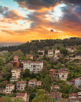 Aerial shot of the mountains of the Asian side of Istanbul, Turkiye at Uskudar, with traditional Turkish houses and lush greeneries at sunset time in a spring day