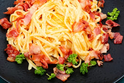 Pasta with carbonara sauce, bacon, parmesan and eggs. Top view.
