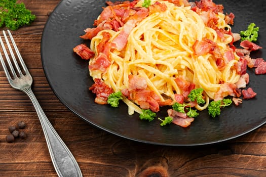 Pasta with carbonara sauce, bacon, parmesan and eggs. Top view.