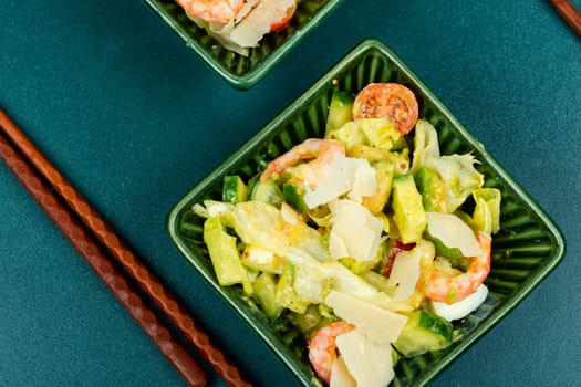 Asian salad with shrimps ,prawns avocado slices and tomato. Top view, close up.
