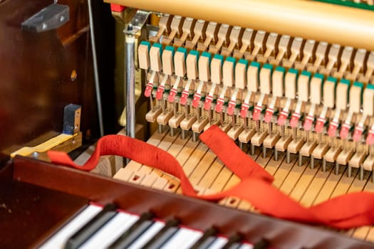 Shallow focus close-up of tools for tuning the internal mechanisms of an upright piano. Gives a feeling of luxury, classic, luxury, grandeur. Pictures can be used on various topics related to music.