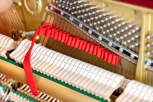 Shallow focus close-up of tools for tuning the internal mechanisms of an upright piano. Gives a feeling of luxury, classic, luxury, grandeur. Pictures can be used on various topics related to music.