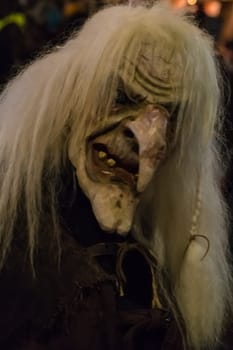 Villach, Austria - November 29, 2019: A Krampus, a horned, anthropomorphic pre-christian traditional figure in the Alpine Region, at the yearly Perchtenlauf in Villach.