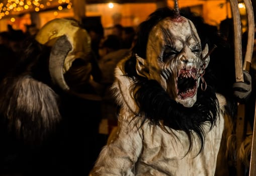 Villach, Austria - November 29, 2019: A Krampus, a horned, anthropomorphic pre-christian traditional figure in the Alpine Region, at the yearly Perchtenlauf in Villach.