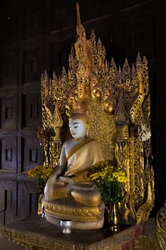 Buddha statue at the Bagaya Monastery, built from teak wood, located at the former capital of Inwa, Myanmar