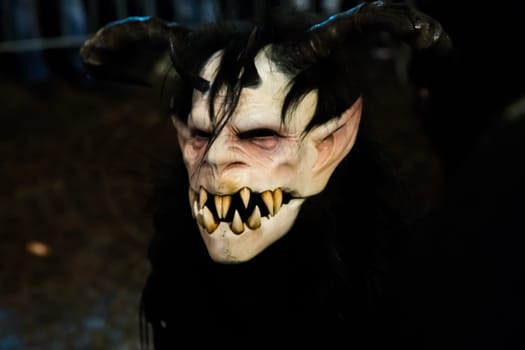 Villach, Austria - November 29, 2019: A Krampus, a horned, anthropomorphic pre-christian traditional figure in the Alpine Region, at the yearly Perchtenlauf in Villach.