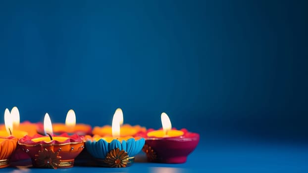 Happy Diwali - Clay Diya lamps lit on blue background during Diwali celebration. Neural network generated in May 2023. Not based on any actual scene or pattern.