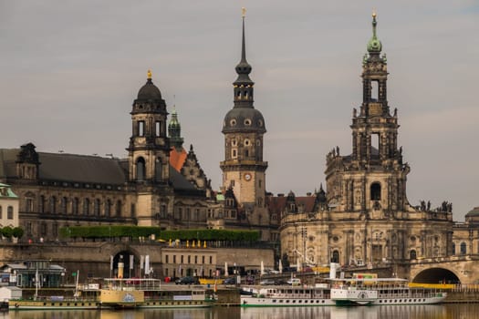 Dresden, Germany - May 20th, 2019: View over the river Elbe with some steamboats to the impressive baroque buildings of the oldtown of Dresden.