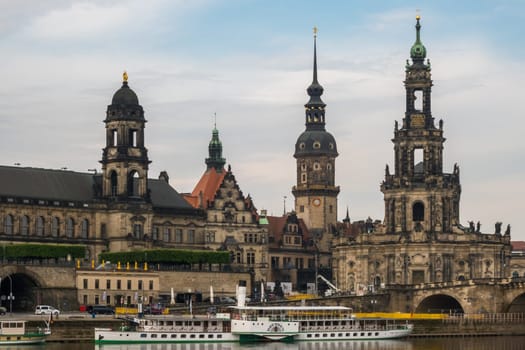 Dresden, Germany - May 20th, 2019: View over the river Elbe with some steamboats to the impressive baroque buildings of the oldtown of Dresden.