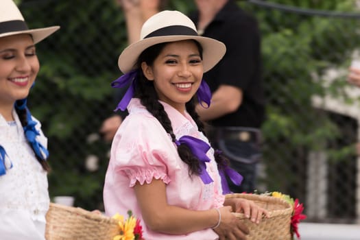 Villach, Austria - August 3th, 2019: A smiling lady from Ecuador at the procession of 'Villacher Kirchtag', the largest traditional folk festival in Austria.