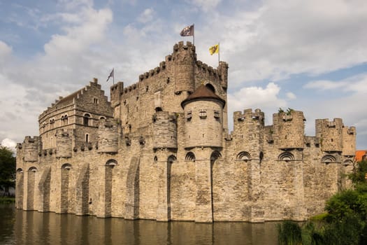 View to the medieval Gravensteen Castle in Ghent surrounded by water