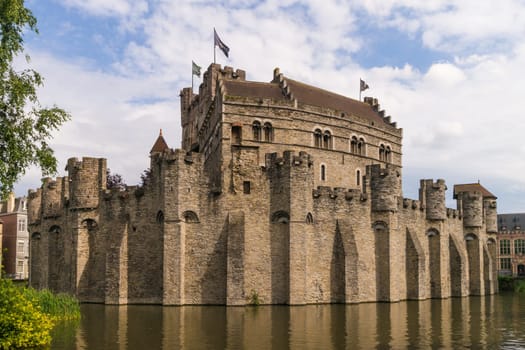 View to the medieval Gravensteen Castle in Ghent surrounded by water