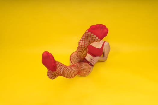 Seductive attractive blonde woman posing in fashionable lingerie in a studio