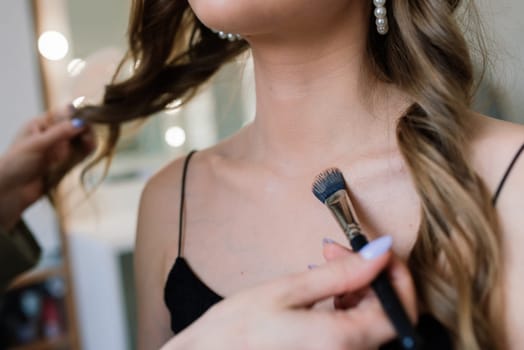 Woman applying by professional make up master. Beauty club conception