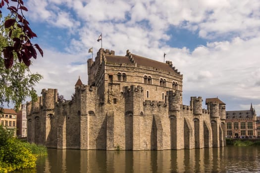 View to the medieval Gravensteen Castle in Ghent surrounded by water
