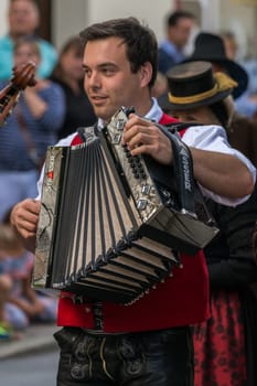Villach, Austria - August 3th, 2019: A traditional musician entertaining at the procession of 'Villacher Kirchtag', the largest traditional folk festival in Austria.