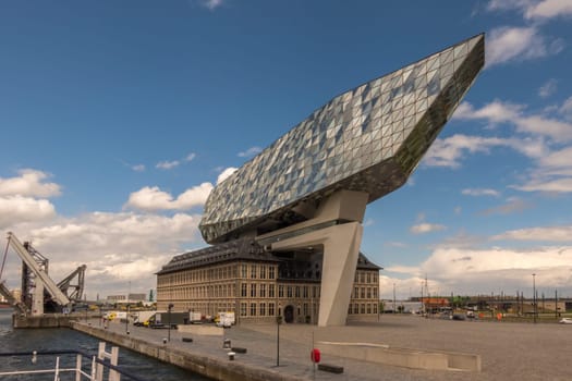 Antwerp, Belgium - June 8th, 2019: View to the unique Port House, home of the port authority's head office, at the port of Antwerp.