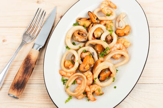 Roasted mussels, squid and shrimp and chopsticks