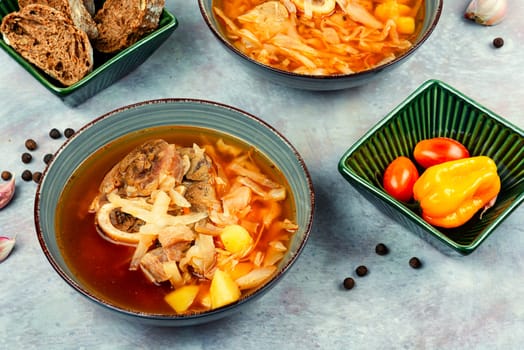 Tasty borshch, soup with meat on the table. Traditional Ukrainian Russian borscht.