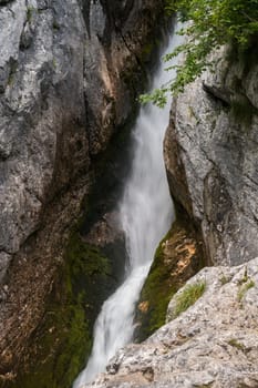 Little waterfall fight at the source of the river Soca in the rocks of Trenta Valley in the Triglav National Park of Slovenia.