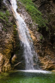 One of the hidden Zapotok waterfalls in upper Trenta Valley in Slovenia, formed by the playful Suhi Potok stream.