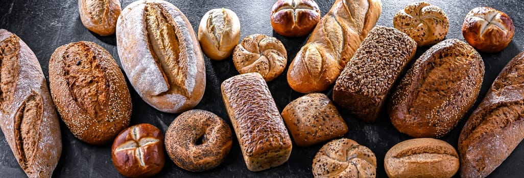 Assorted bakery products including loaves of bread and rolls.