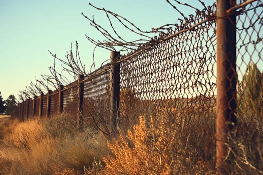 Arid Usa mexico border view. Crossing metal barrier fence. Generate Ai