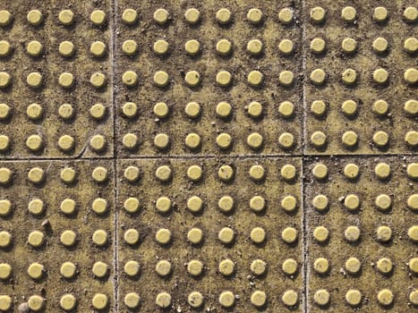 yellow tactile pavement tiles for the blind, background