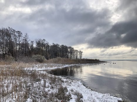Winter landscape of the shore of the Gulf of Finland, dramatic clouds reflected in the sea