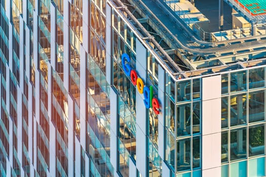 tokyo, japan - jan 21 2024: Close up bird's eye view of a bay window at the corner of the facade of the skyscraper of the internet communications giant Google with its colorful logo on the storefront.