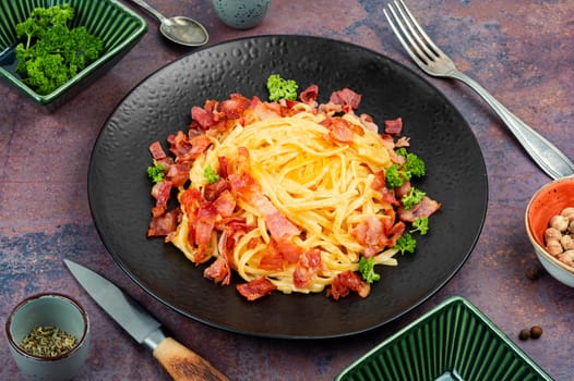 Delicious pasta with fried bacon on a plate, pasta carbonara. Keto diet.