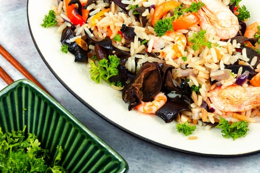 Chinese food, fried rice with shrimp and mushrooms. Asian food style. Top view.