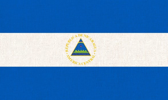 Flag of Nicaragua. Nicaragua flag on fabric surface. Fabric Texture. National symbol. Republic of Nicaragua. Caribbean country