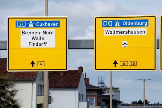 Signposts to the highway and country road, residential buildings, Bremen, Germany
