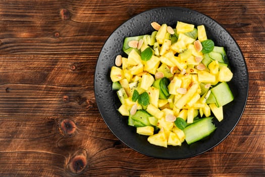 Vegan exotic juicy pineapple, ananas cucumber salad. Healthy, balanced, diet food.