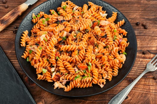 A plate of pasta with seafood, pasta with mussels and creamy garlic sauce. Space for text.