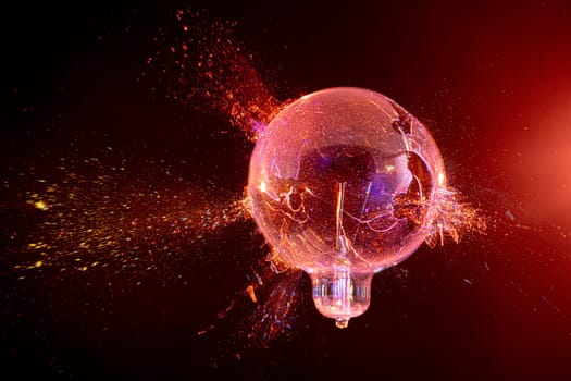 explosion of a glass bulb on a black background. high-speed photography