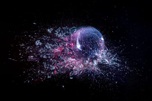 explosion of a glass ball on a black background. high-speed photography