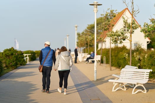 Couple walking on the beach promenade of Kühlungsborn on the German Baltic Sea coast