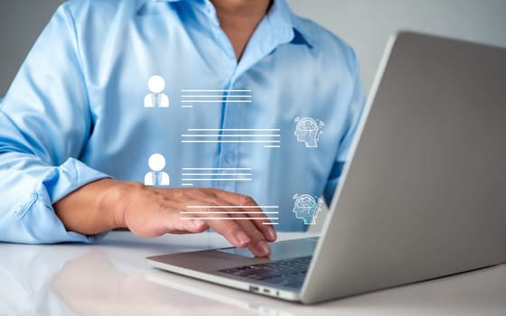 Businessman use computer technology to type live chat with intelligent computer to find information, ask, answer with an artificial intelligence system, chatbot, Ai assistant.