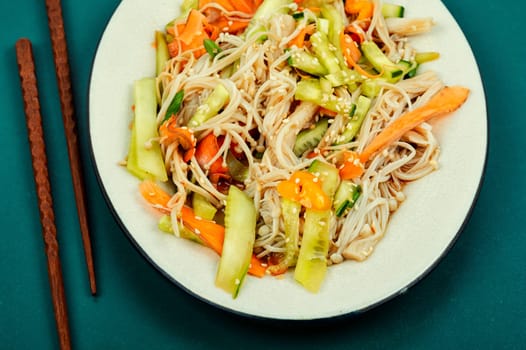 Plate with salad of enoki mushrooms or needle mushroom and vegetables. National Chinese food.