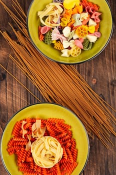 Different sorts of uncooked pasta, macaroni, noodles and spaghetti. Copy space.
